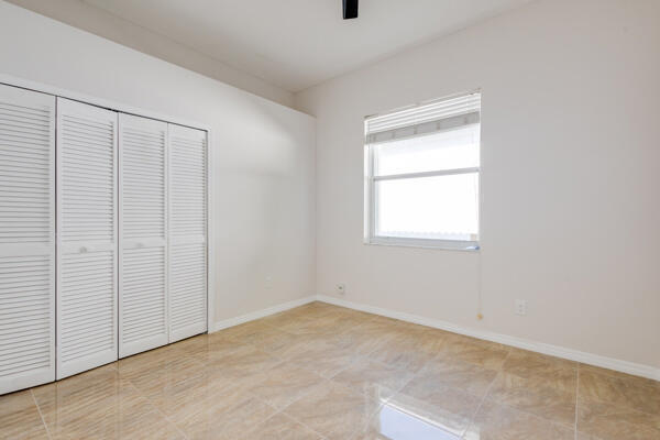 unfurnished bedroom with light tile patterned flooring and a closet