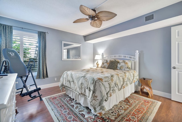 bedroom with ceiling fan and hardwood / wood-style flooring