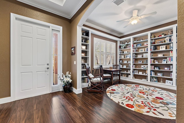 foyer entrance with dark hardwood / wood-style flooring, ornamental molding, and ceiling fan