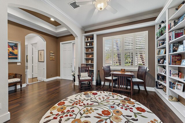 interior space with dark hardwood / wood-style flooring, ceiling fan, and crown molding