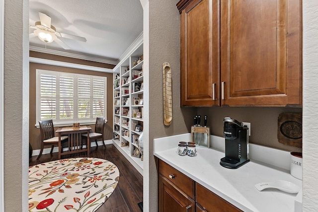 interior space featuring dark wood-type flooring, ceiling fan, and ornamental molding