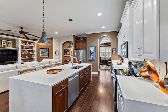 kitchen with stainless steel appliances, white cabinetry, ceiling fan, and an island with sink