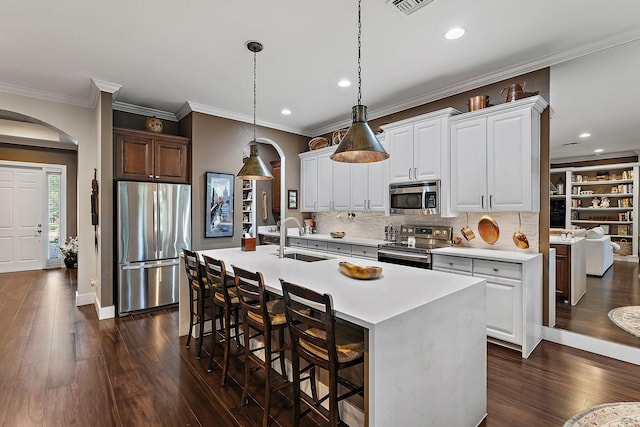 kitchen featuring stainless steel appliances, sink, a kitchen island with sink, and white cabinets