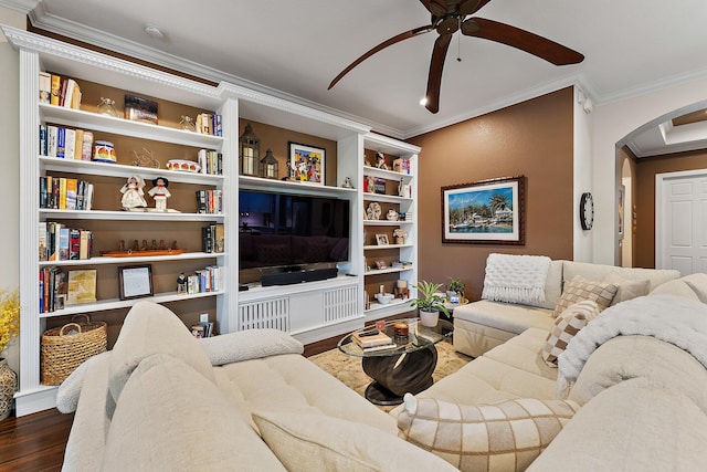 living room with ornamental molding, dark wood-type flooring, and ceiling fan