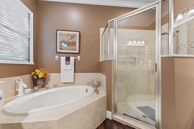 bathroom featuring independent shower and bath and ornamental molding