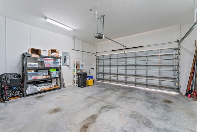 garage featuring electric panel and a garage door opener