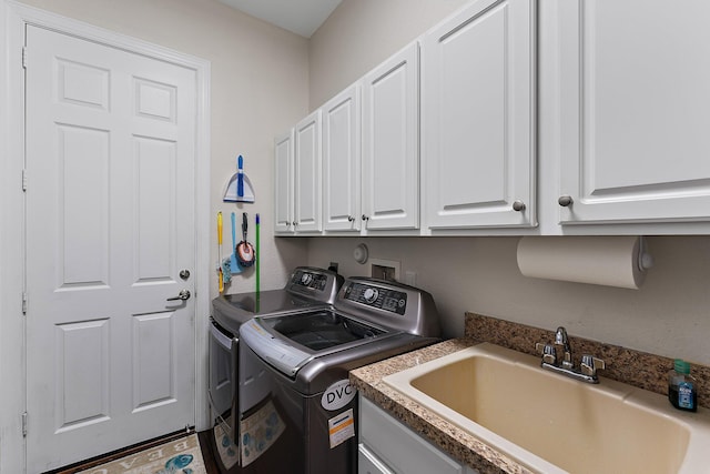 laundry room with cabinets, sink, and washer and clothes dryer