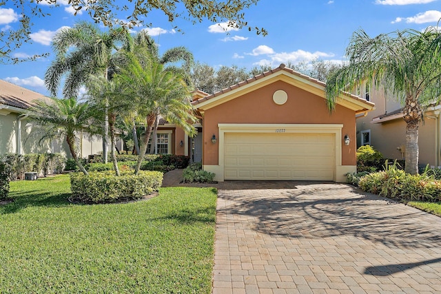 view of front of house with a garage and a front lawn