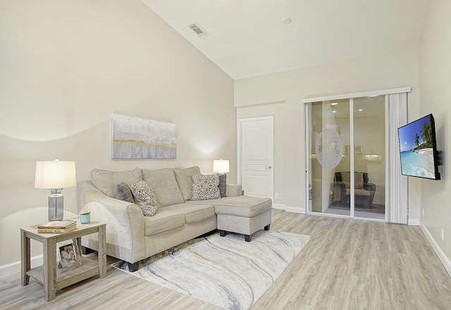 living room with lofted ceiling and hardwood / wood-style floors