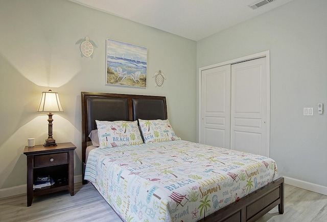 bedroom with a closet and light hardwood / wood-style floors