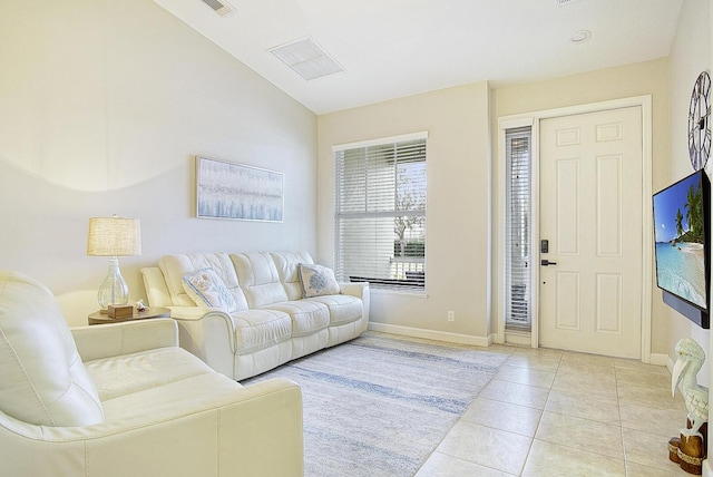 tiled living room featuring lofted ceiling