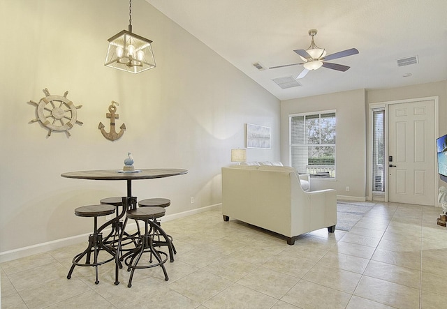 tiled living room with ceiling fan with notable chandelier and vaulted ceiling