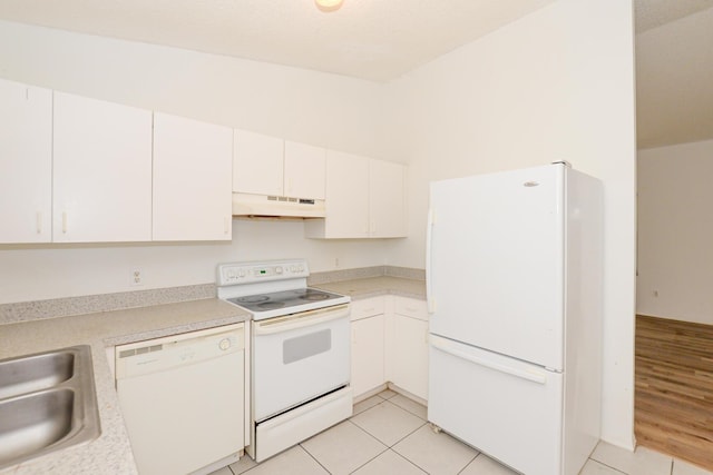 kitchen featuring sink, white appliances, white cabinetry, and light tile patterned flooring