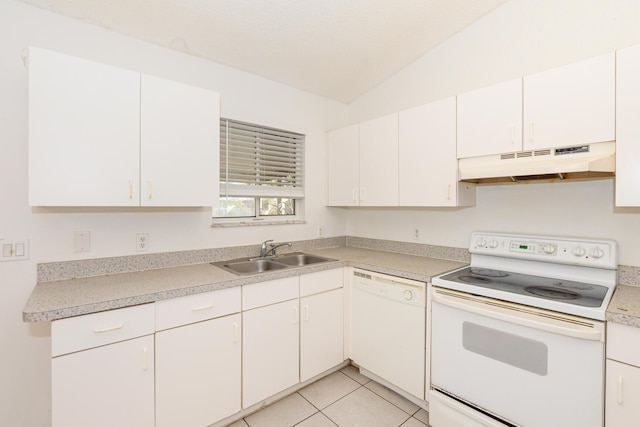 kitchen with white appliances, white cabinetry, light tile patterned floors, and sink