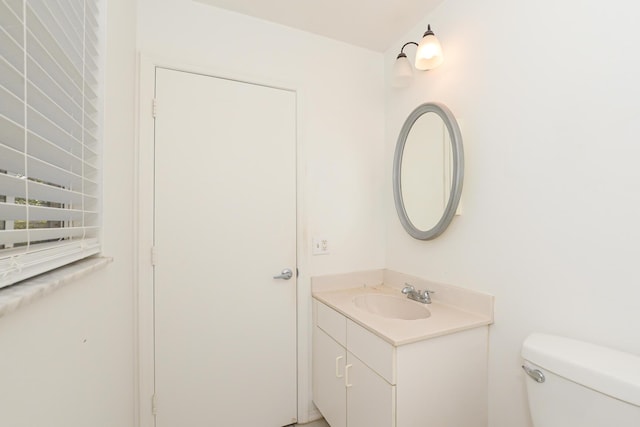 bathroom featuring toilet and vanity