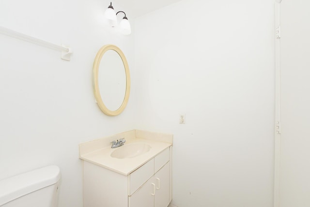 bathroom with toilet and vanity