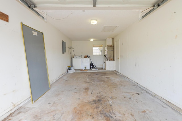 garage featuring electric panel and washer and dryer