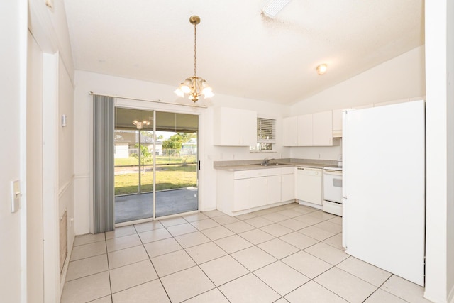 kitchen with white appliances, lofted ceiling, white cabinets, light tile patterned flooring, and sink