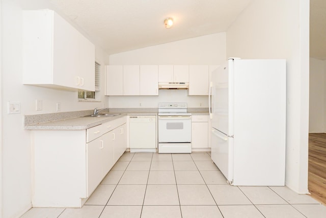 kitchen featuring white appliances, vaulted ceiling, white cabinets, light tile patterned flooring, and sink