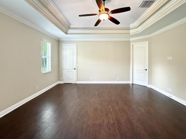 unfurnished room with a tray ceiling, ornamental molding, dark hardwood / wood-style floors, and ceiling fan