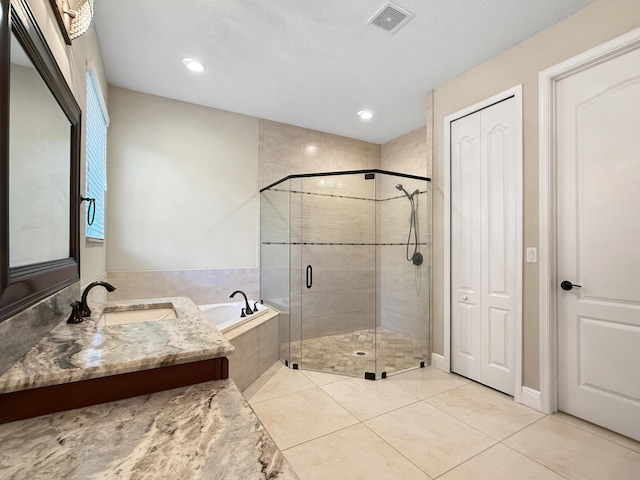 bathroom featuring vanity, tile patterned flooring, and plus walk in shower