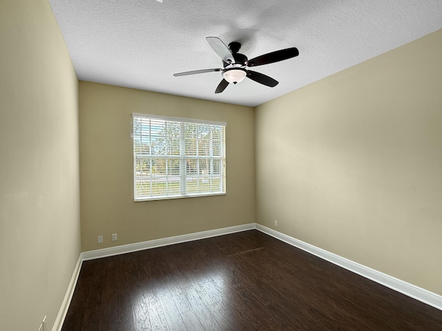 empty room with ceiling fan, a textured ceiling, and dark hardwood / wood-style flooring