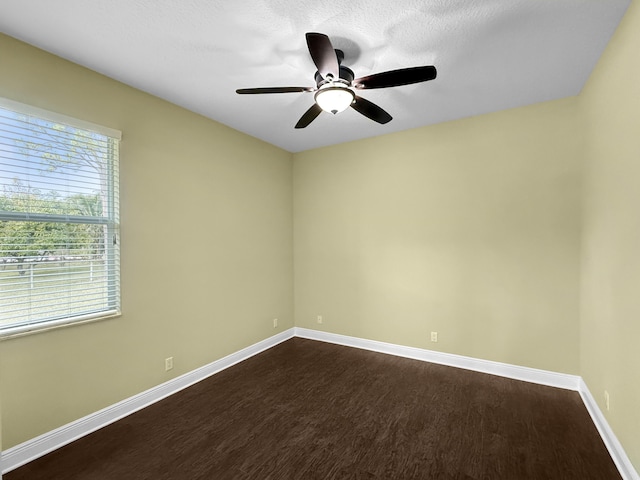 spare room with ceiling fan, hardwood / wood-style floors, and a wealth of natural light