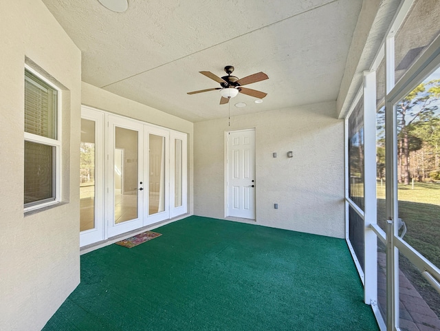 unfurnished sunroom featuring french doors, ceiling fan, and plenty of natural light