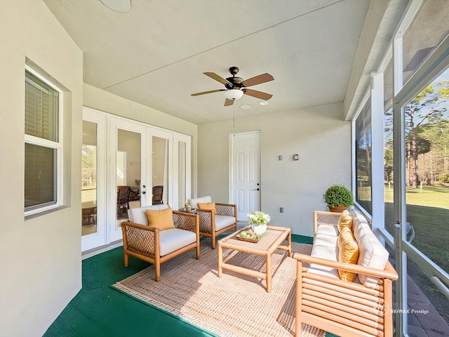 sunroom / solarium featuring french doors and ceiling fan