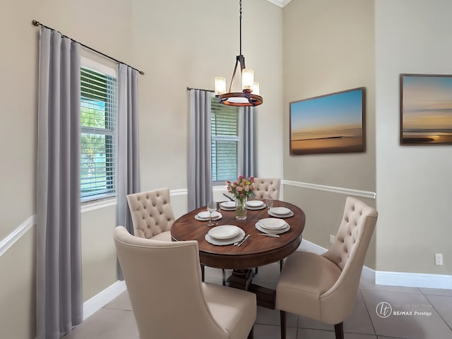 tiled dining space with an inviting chandelier