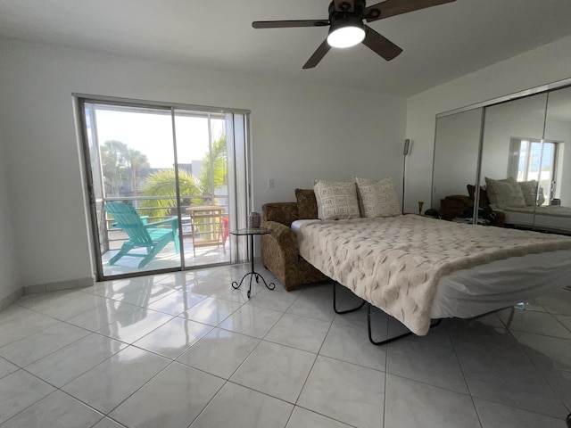 tiled bedroom with ceiling fan, access to outside, and a closet