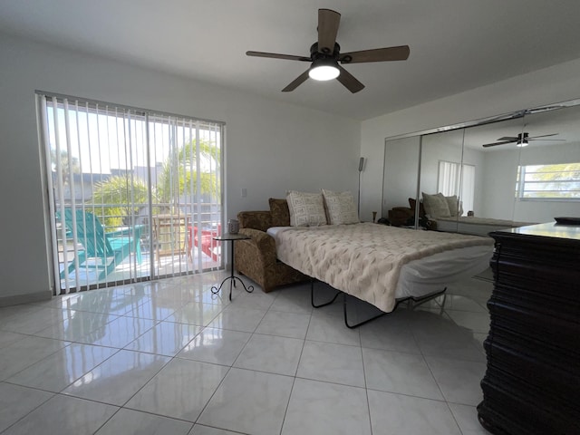 tiled bedroom with ceiling fan, access to outside, and a closet