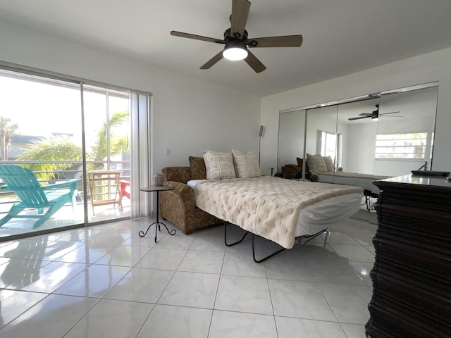 tiled bedroom with ceiling fan, access to outside, and a closet