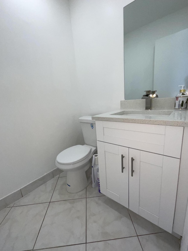 bathroom with tile patterned floors, vanity, and toilet