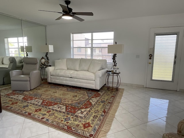 living room featuring ceiling fan and light tile patterned floors