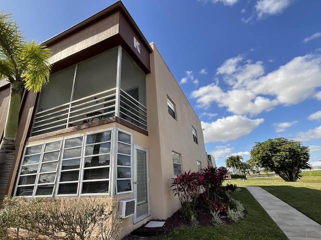 view of side of home with a lawn