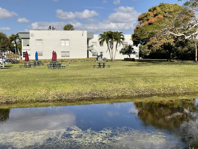 exterior space with a lawn and a water view