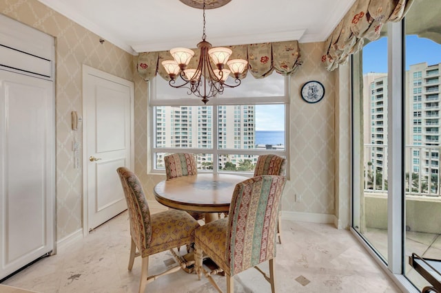 dining area with a water view, an inviting chandelier, and crown molding