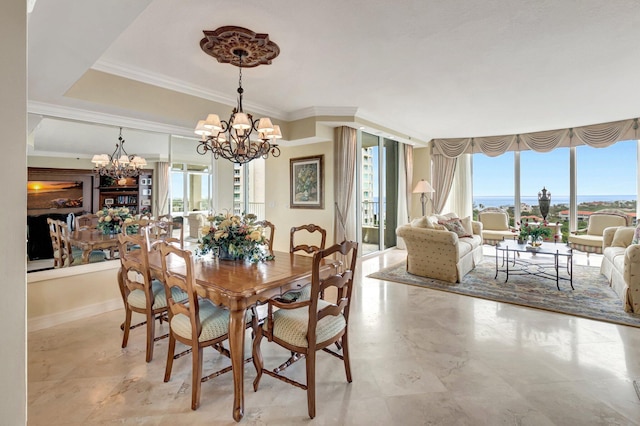 dining space with a healthy amount of sunlight, a notable chandelier, and crown molding