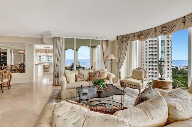 living room with a water view, a healthy amount of sunlight, and an inviting chandelier