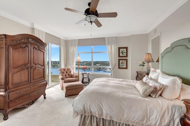 bedroom with light carpet, ceiling fan, ornamental molding, and a water view