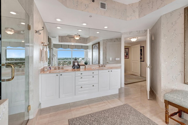 bathroom with vanity and a shower with door