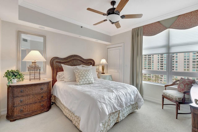 carpeted bedroom featuring ceiling fan and ornamental molding