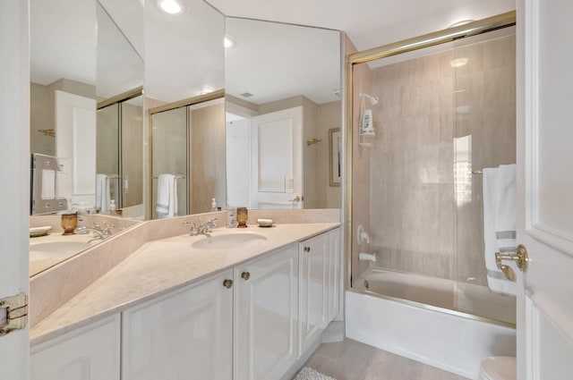 bathroom with combined bath / shower with glass door, tile patterned floors, and vanity