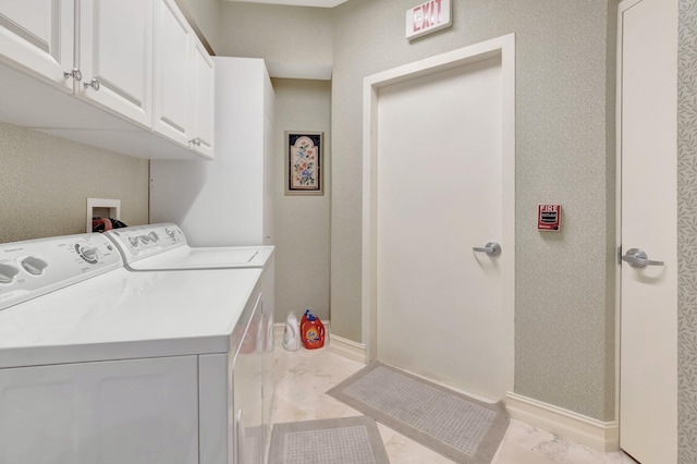 washroom with cabinets and separate washer and dryer