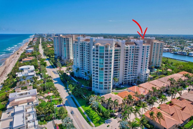 bird's eye view featuring a water view and a view of the beach