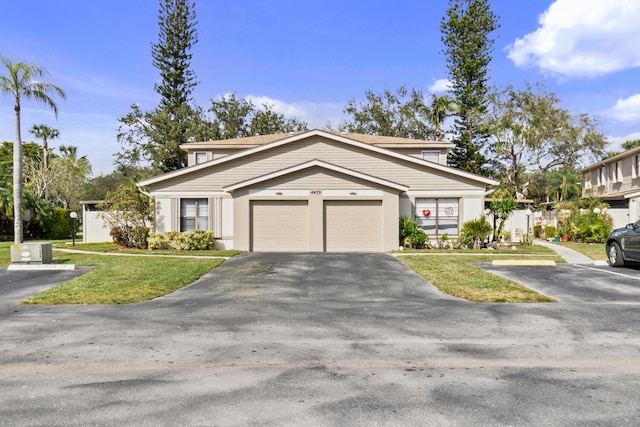 view of front of house with a garage and a front lawn