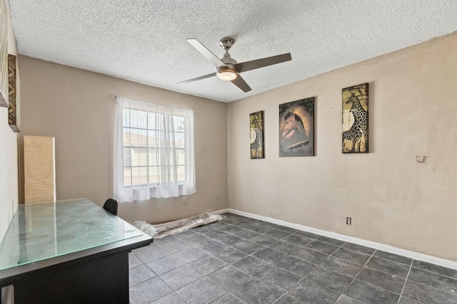 interior space with ceiling fan and a textured ceiling