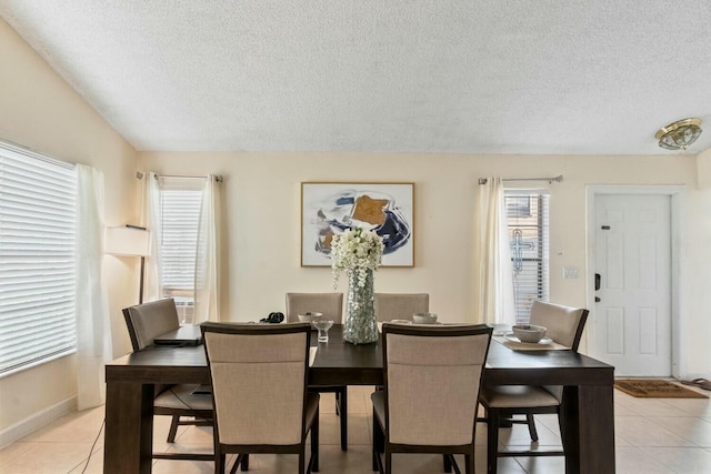 tiled dining area with a textured ceiling