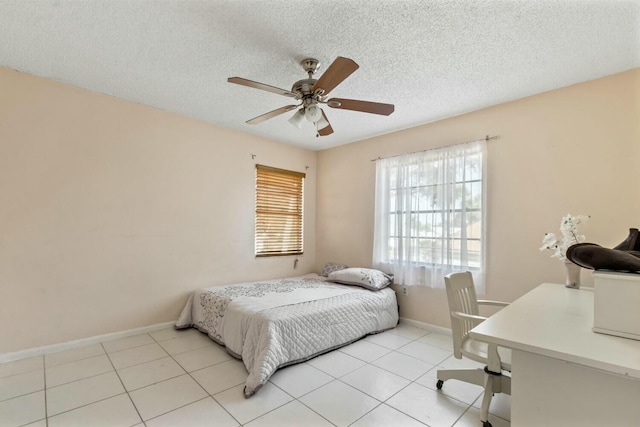 tiled bedroom featuring ceiling fan and a textured ceiling